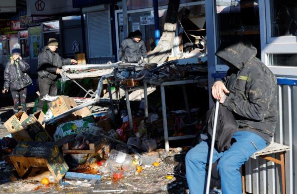 Residents remove debris from a food market following the shelling in the Russian-co<em></em>ntrolled Do<em></em>netsk region of Ukraine on Jan. 21, 2024.