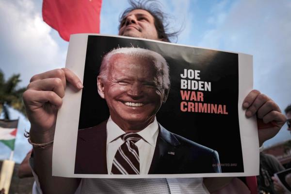 A protester holds a placard depicting US President Joe Biden, during a rally co<em></em>ndemning the support of the US towards Israel, in San Jose, Costa Rica, 16 January 2024