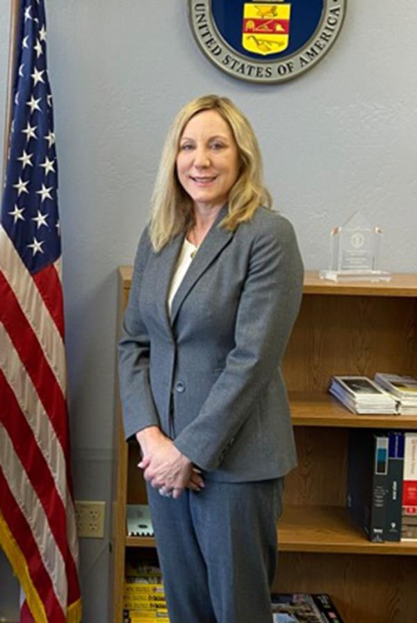 So<em></em>noma County DA Carla Rodrgiuez standing next to an American flag.