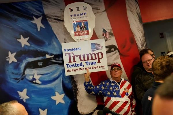 James A. Zecca, from Utica, NY., holding up a Trump sign as he waits to hear from House Republican Co<em></em>nference Chair Elise Stefanik, during a campaign event at Team Trump New Hampshire headquarters, Saturday, Jan. 20, 2024, in Manchester, NH. (AP Photo/Pablo Martinez Monsivais)